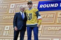 Juho Piiparinen, right, stands with NHL Commissioner Gary Bettman after being drafted by the Ve ...