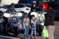 Karen Romero takes a picture of her children Thiago, 7, left, and Sebastian, 5, as they pose in ...