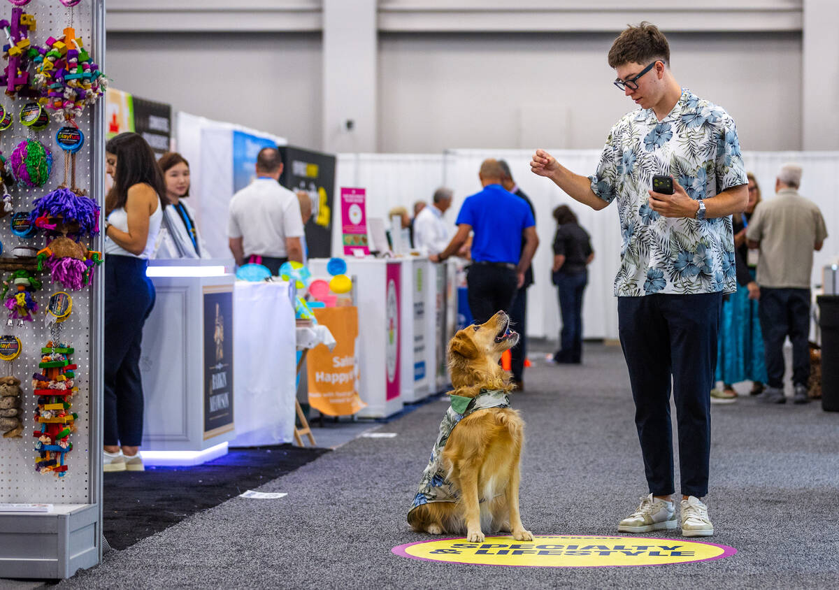 Johnny Perez works with his dog Aubrey as they wear matching outfits during SUPERZOO at the Man ...
