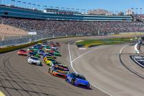 Denny Hamlin (11) leads Chase Briscoe (19) and the rest of the field out of turn one at the sta ...