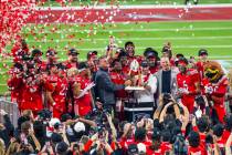 The championship trophy is delivered to the Utah Utes players and head coach Morgan Scalley aft ...