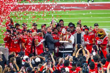 The championship trophy is delivered to the Utah Utes players and head coach Morgan Scalley aft ...