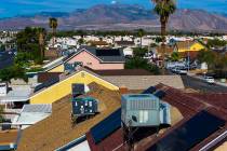 Air conditioning units on home rooftops in a neighborhood off of West Washington Avenue on Aug. ...