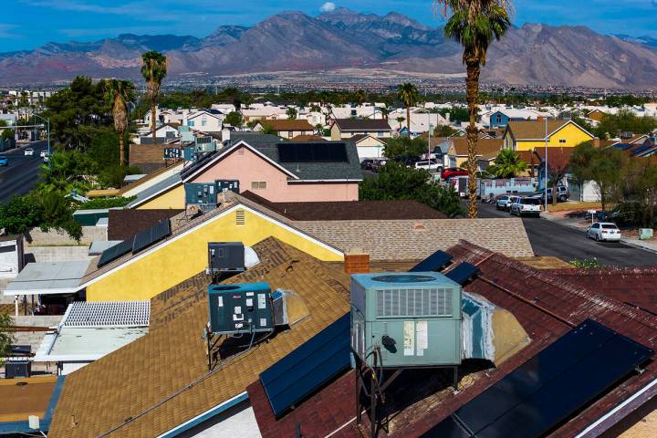 Air conditioning units on home rooftops in a neighborhood off of West Washington Avenue on Aug. ...