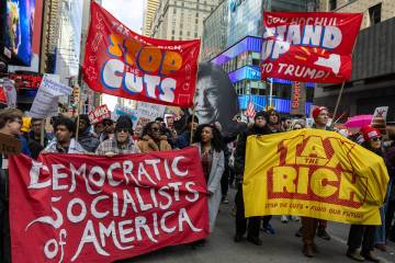 New York City, New York USA - March 28 2026 Protesters carry banners reading “Democrati ...