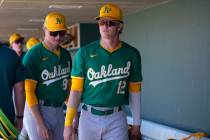 Oakland Athletics' Jack Winkler (12) and Will Simpson, left, walk through the dugout prior ...