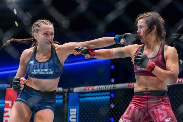 Alex Apodaca lunges forward to punch Bella Mir during the 135-pound bantamweight contest at Dan ...