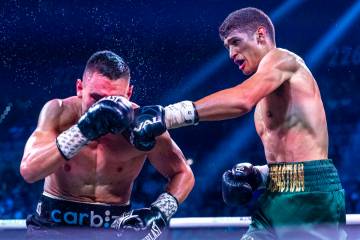 Tim Tszyutakes a shot to the face from Sebastian Fundora during their WBC super welterweight ch ...