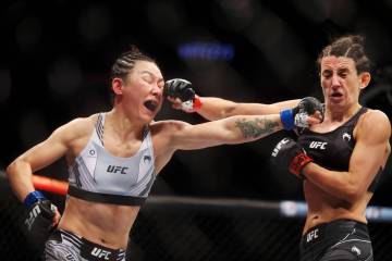Yan Xiaonan, left, battles Marina Rodriguez, in the third round of the women’s strawweight bo ...