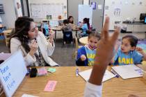 Student teacher Cinthia Garcia works with Samantha Leyva De La Vega, left, and Olivia Alvarez L ...