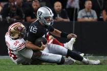 Las Vegas Raiders quarterback Fernando Mendoza (15) gets sacked by San Francisco 49ers defensiv ...