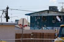 Clark County firefighters work on a fire that spread to two houses in a neighborhood on Wednesd ...