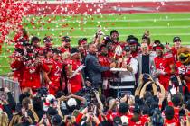 The championship trophy is delivered to the Utah Utes players and head coach Morgan Scalley aft ...