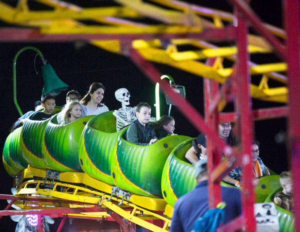 Attendees bask  the Wacky Worm Coaster astatine  HallOVeen. (Benjamin Hager Las Vegas Review-Journal)
