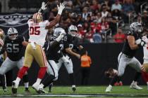 Raiders quarterback Kirk Cousins (8) throws a pass as Tyler Linderbaum (65) provides protection ...