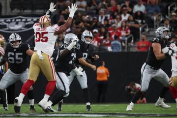 Raiders quarterback Kirk Cousins (8) throws a pass as Tyler Linderbaum (65) provides protection ...
