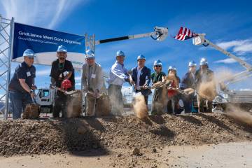 Officials shovel dirt during a groundbreaking ceremony for GridLiance West, which will see new ...