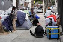 Homeless people gather with their belongings and tents in the Mission District, Tuesday, Sept. ...
