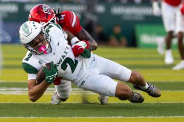 UNLV defensive back Tony Louis Nkuba (4) stops Hawai‘i wide receiver Audric Harris (2) d ...