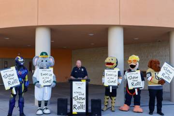 CCSD Police Lt. Bryan Zink, flanked by local sports team mascots, speaks during a press confere ...