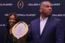 Rich Clark, right, executive director of the College Football Playoff, shares a laugh with Sand ...
