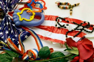 Balloons, plastic flowers, a rosary and flags from the "Heroes of 9-11" display collection, pre ...