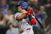 Toronto Blue Jays' Kazuma Okamoto hits a single during the sixth inning of a baseball game ...