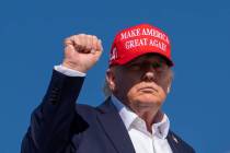 President Donald Trump gestures while boarding Air Force One at Morristown Airport, Monday, Sep ...