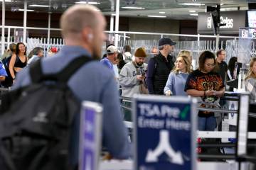 Travelers wait at a Transportation Security Administration checkpoint at Harry Reid Internation ...