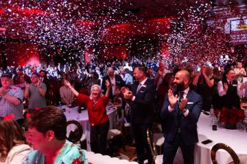 Employees celebrate after learning that they will be given company stock during an event celebr ...