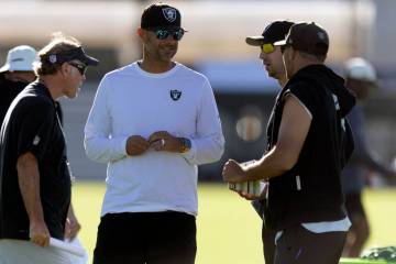 Raiders general manager John Spytek, left, meets with head coach Klint Kubiak, center, and defe ...
