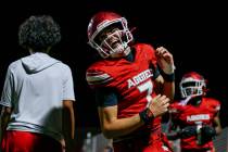 Arbor View quarterback Thaddeus Thatcher (7) grins as he runs to the sidelines after scoring a ...