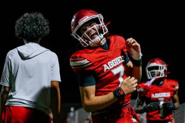 Arbor View quarterback Thaddeus Thatcher (7) grins as he runs to the sidelines after scoring a ...