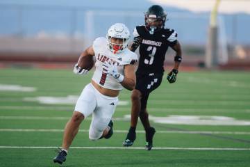 Liberty running back Ezra Sanelivi (1) runs the ball during a high school football game against ...