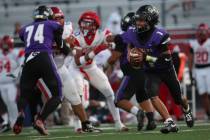 Sunrise Mountain's August Krael (1) looks to pass the ball during a football game at Valle ...
