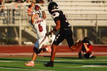 Liberty wide receiver Kainalu Hosaka (6) catches the ball for a touchdown against Desert Oasis ...