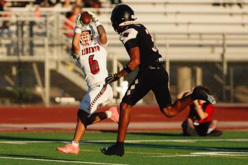 Liberty wide receiver Kainalu Hosaka (6) catches the ball for a touchdown against Desert Oasis ...