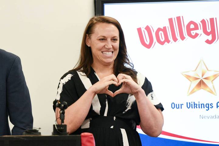 Valley High School teacher Brooke Wheatley makes a heart sign for her students when they are in ...