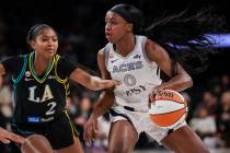 Aces guard Jackie Young (0) drives the ball under pressure from Los Angeles Sparks guard Chance ...