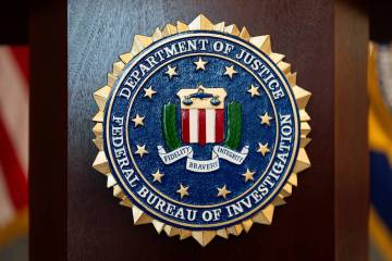 FILE - An FBI seal is displayed on a podium before a news conference at the field office in Por ...