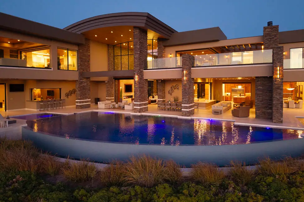 Infinity-edge pool with a swim-up bar at the $24.5 million Empire Estate on Dragon Ridge Drive, overlooking the Las Vegas Valley