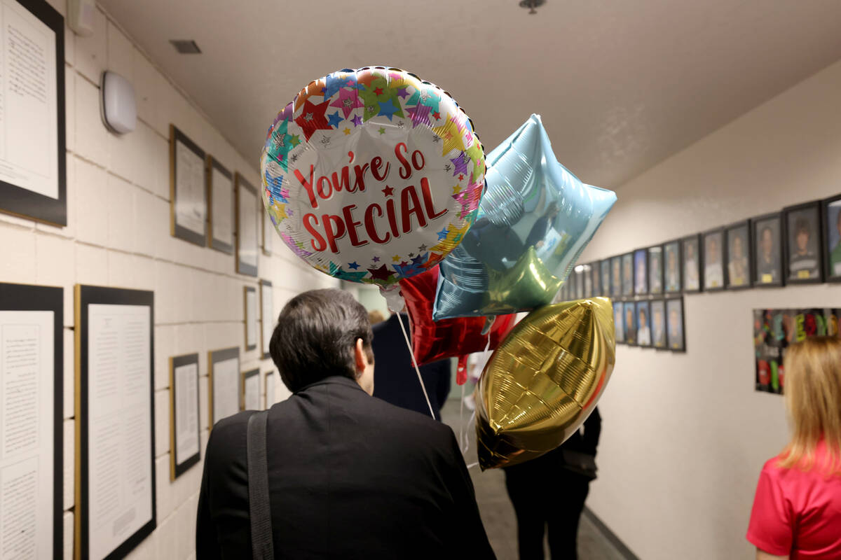 Michael Mitchell of the Nevada Department of Education Office of Early Learning and Development carries balloons ahead of the surprise award ceremony at Piggott Academy in Las Vegas