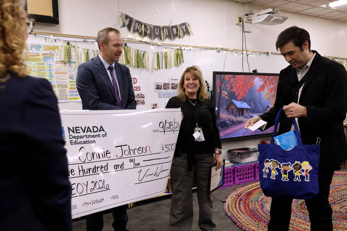 Piggott Academy preschool teacher Connie Johnson reacts in her classroom as Nevada Superintendent Dr. Victor Wakefield presents the Nevada Early Educator of the Year award
