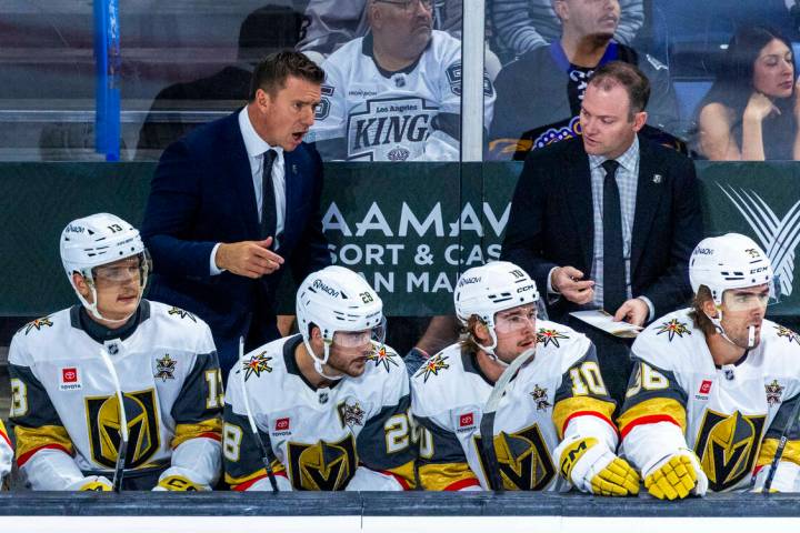 Golden Knights head coach Ryan Craig confers with a coach during the first period of their NHL ...