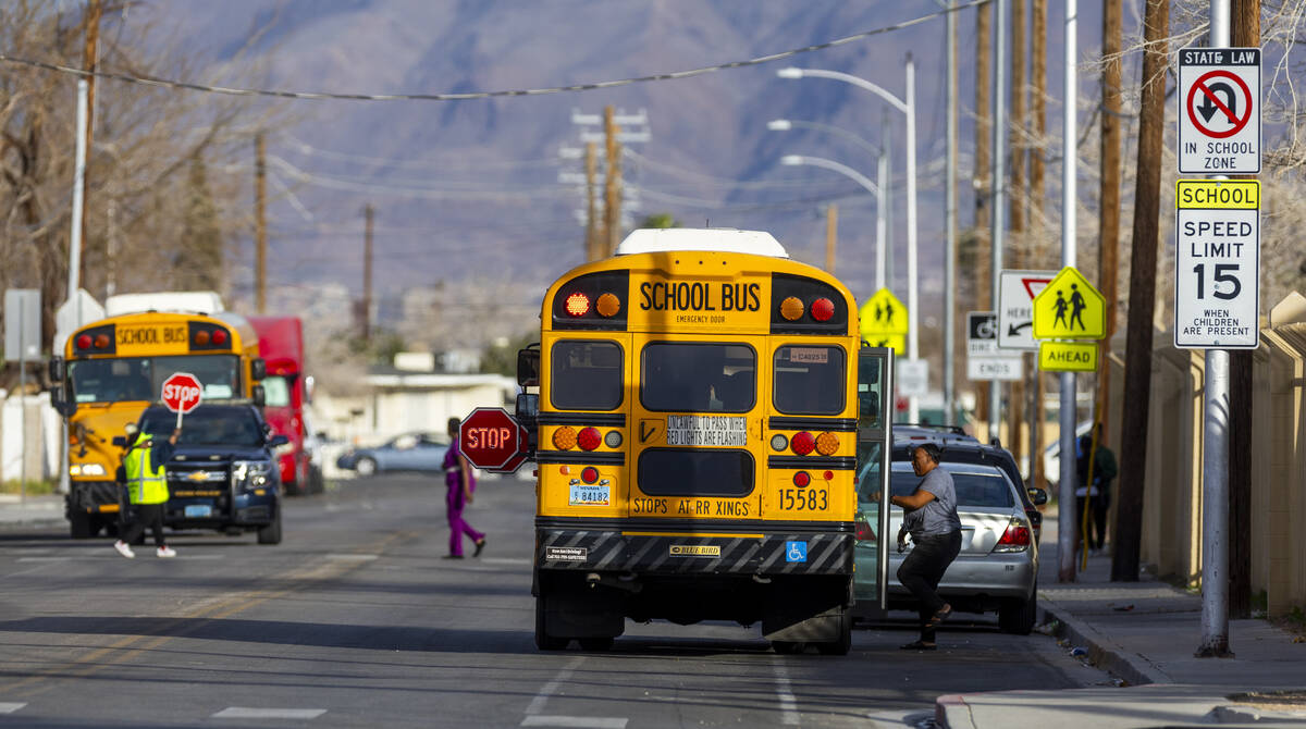 A line of yellow CCSD school buses arrives to pick up students at Kelly Elementary School in Las Vegas