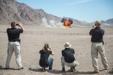 Members of local law enforcement watch an explosion during the grand opening ceremony of the El ...