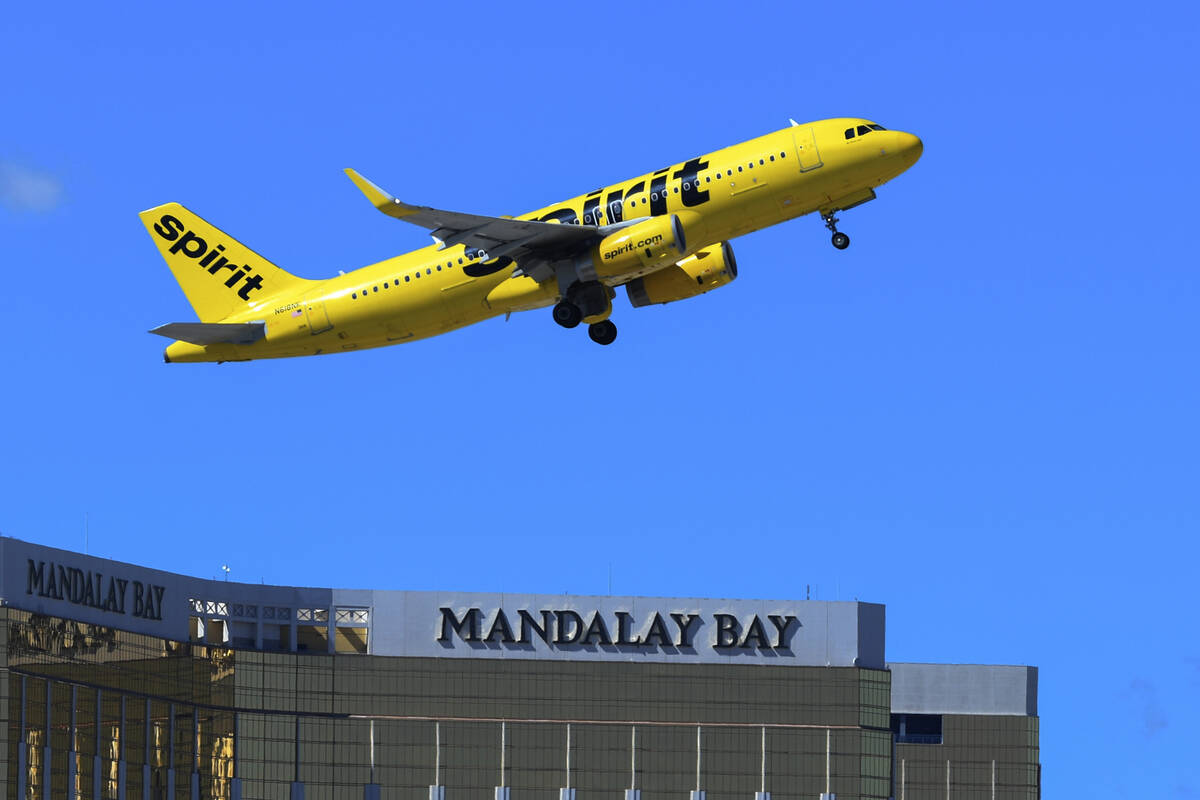 A yellow Spirit Airlines jet climbs past the Mandalay Bay sign after takeoff from Harry Reid International Airport, before the carrier stopped flying in May 2026