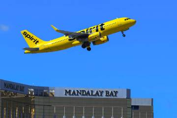 A Spirit Airlines jet takes off from Harry Reid International Airport with Mandalay Bay in the ...