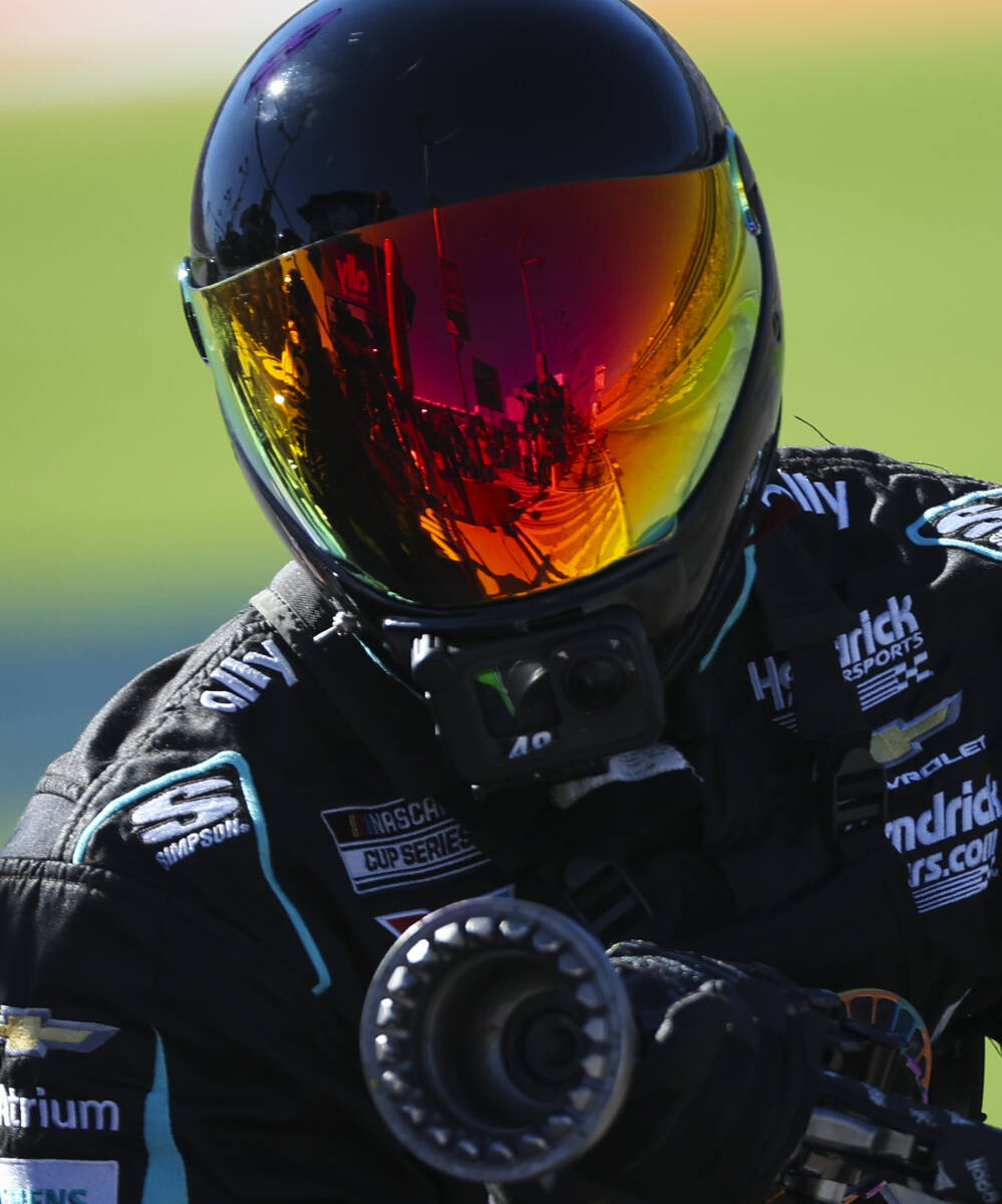 Pit road is reflected in the visor of a crew member for driver Alex Bowman during the South Poi ...